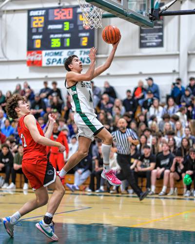 Evan Berkeley drives to the basket for a layup during Monday’s 65-47 win for the Spartans over Coe-Brown.