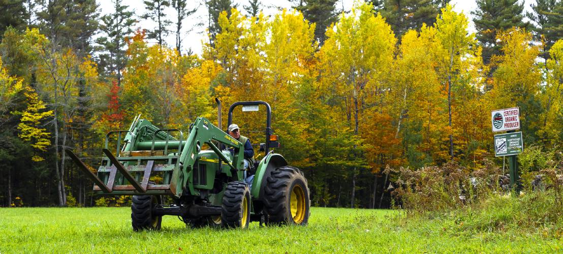 Dan Wolf of Newbury on his tractor in a field that he grows organic hay as well as organic eggs on 200 acres on Friday, October 15, 2021.