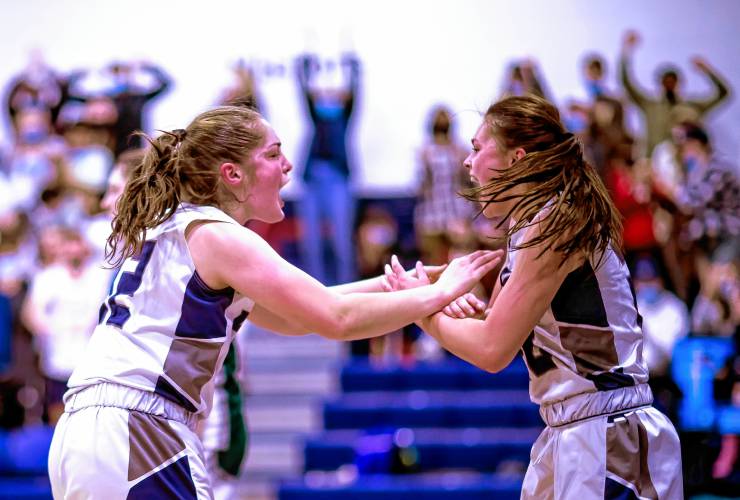 From left, Mackenzie McDonald and Macy Gordon are fired up during a Merrimack Valley girls’ basketball game against Pembroke in 2022. The two, who have played basketball together since they were in elementary school, are in their third year together at New England College, extending their playing careers at a level neither expected.