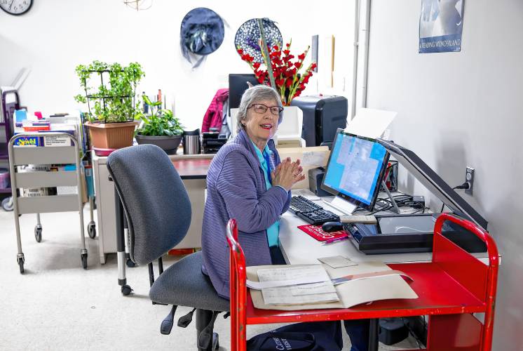 Concord Library volunteer Ginny Babczak prepares to scan in materials for the digital archive for the library. Babczak is a former librarian who comes in to scan materials. The archive goes up live on Dec. 9.