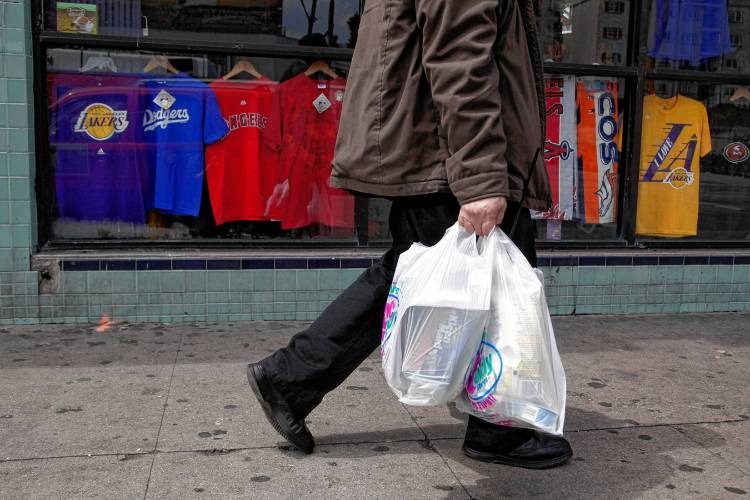 A man walks along the street with plastic bags in Los Angeles, Thursday, May 24, 2012. A man walks along the street with plastic bags in Los Angeles, Thursday, May 24, 2012.