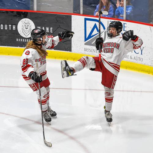 Concord’s Brooke Nelson (right) celebrates with Elliana Wing (22) after Nelson's goal during a game on Saturday at Everett Arena. Concord came back from a 2-0 deficit to beat St. Thomas-Winnacunnet-Dover, 3-2. 