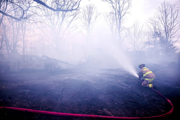 A fire at 100 Chase Farm Road in Hopkinton on Monday afternoon drew firefighters from around the area as flames spread from a garage to surrounding brush and fields.