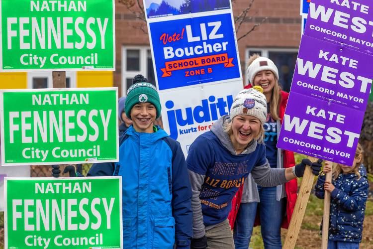 Conor Fennessy (left), Liz Boucher and Ashley Babladelis have some fun outside the Ward 7 polling place at Abbot-Downing Elementary on Tuesday, November 7, 2023.