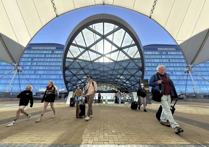 Travelers walk into Denver International Airport on Tuesday, Nov. 21, 2023, in Denver. (Thomas Peipert /AP Photo)