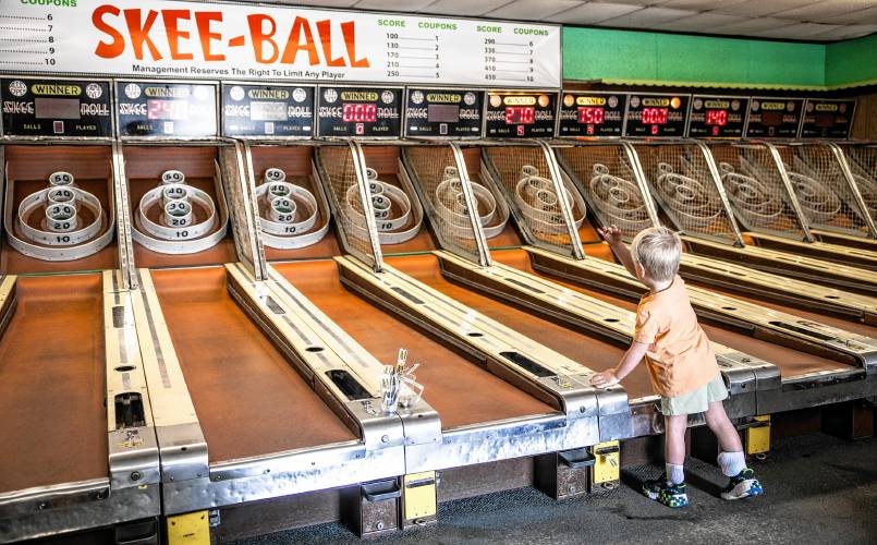 Jackson Lawrence, 3, plays the old-fashioned Skee Ball with his family at Fun Spot in Laconia on Monday, May 6, 2024. The family came on a Monday so the crowds were not there but owner Dave Lawton says that on a rainy day in the summer, the arcade is full of families that have come to the Lakes Region.