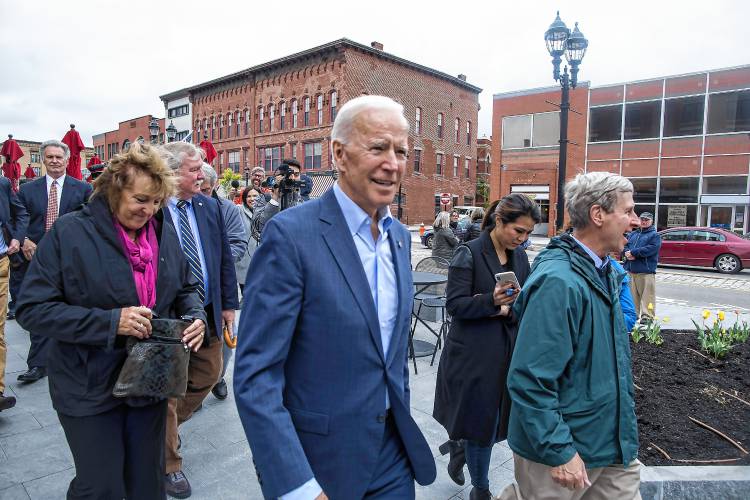 Joe Biden walks down Main Street in Concord after campaigning with voters at The Works downtown on May 14, 2019. He was with Sylvia Larsen, left, Steve Shurtleff, back, and former Gov. John Lynch, right.