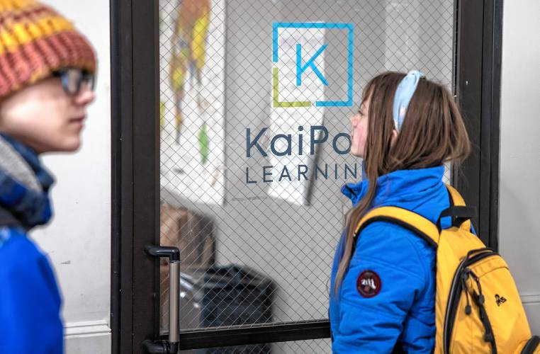 Olive MacQuarrie waits with her brother, Ethan, for the KaiPod Learning Center in Manchester to open on Friday, February 21, 2025.