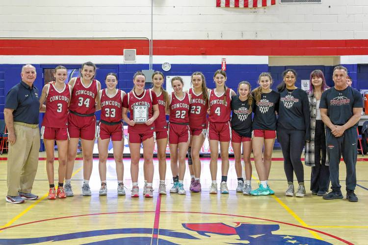 The Concord High School girls’ basketball team poses with the championship plaque after defeating Merrimack Valley, 35-26, on Friday at John Stark Regional High School in Weare to win the Capital Classic holiday tournament title. Concord defeated Pembroke, 47-44 in the semifinals, to advance to the final.