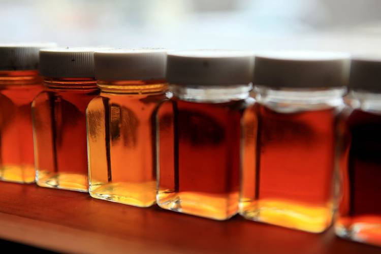 Different colors of maple syrup sit on the windowsill at Maple Ridge Sugar House in Loudon in 2014.