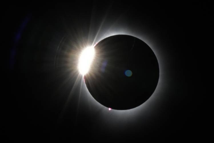 The moon covers most of the sun as it approaches the total solar eclipse, as seen from the summit of Saddleback Mountain near Rangeley, Maine, on Monday. 