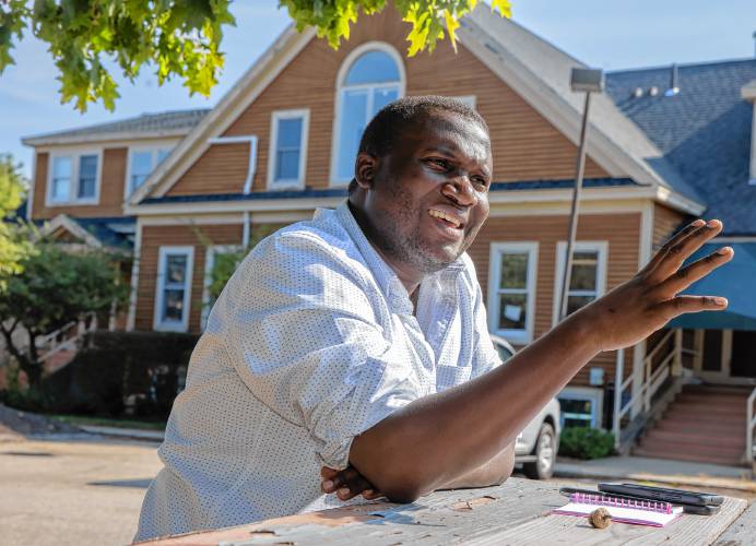 Jean Hakuzimana, founder and director of the organization NH Songa, talks about his role in the community at his office in Concord on Thursday.
