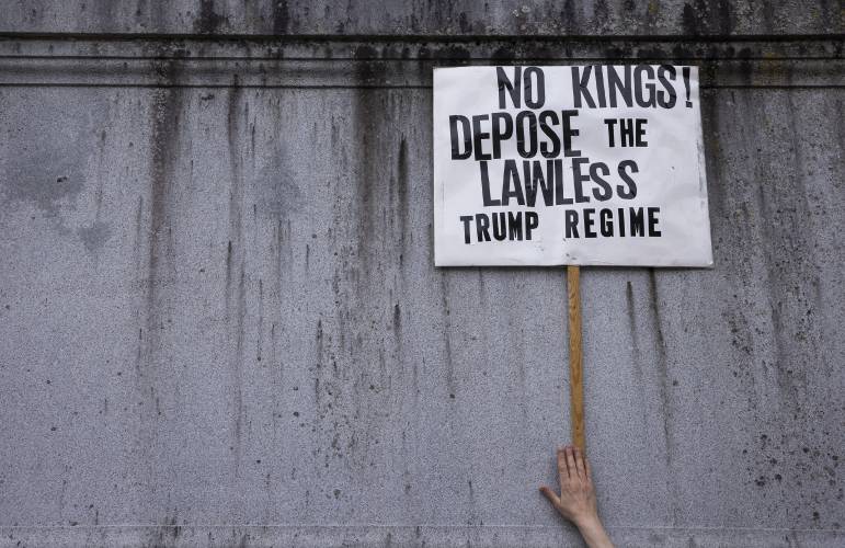 There were many signs at the ‘Hands Off’ protest at the State House on Saturday, April 19, 2025.
