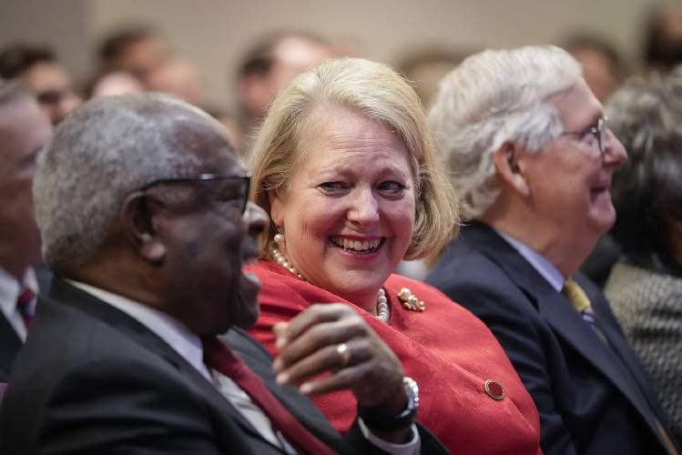 Associate Supreme Court Justice Clarence Thomas, left, sits with his wife, conservative activist Virginia Thomas, while he waits to speak at the Heritage Foundation on Oct. 21, 2021, in Washington, D.C.