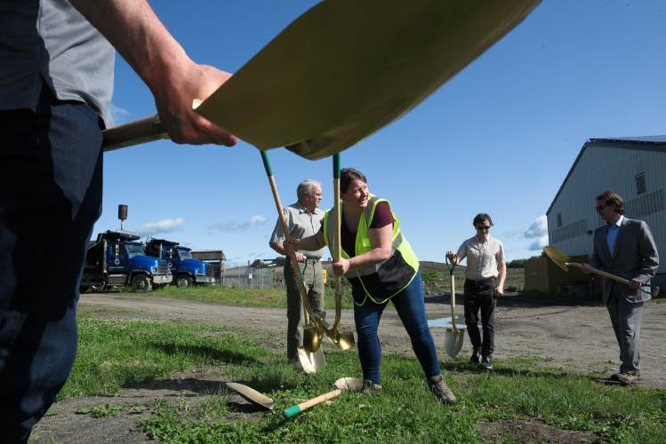 Solid Waste Manager Erica Douglas, center, distributes shovels to, from foreground left, Justin Rathke, president of Vergent, Assistant Mayor Clifton Below, City Councilor Devin Wilkie and City Councilor Doug Whittlesey, before a ground breaking for the City of Lebanon's gas to energy project at the Lebanon Landfill in West Lebanon on  May 28. They system will burn gas produced by the decomposition of waste in the landfill to produce electricity.
