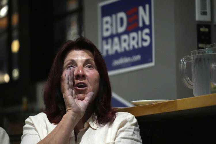 Lynn Miller shouts at the TV after a comment by Republican presidential candidate former President Donald Trump during the presidential debate with President Joe Biden, during a watch party at Broadway Bowl, Thursday, June 27, 2024, in South Portland, Maine. (AP Photo/Robert F. Bukaty)