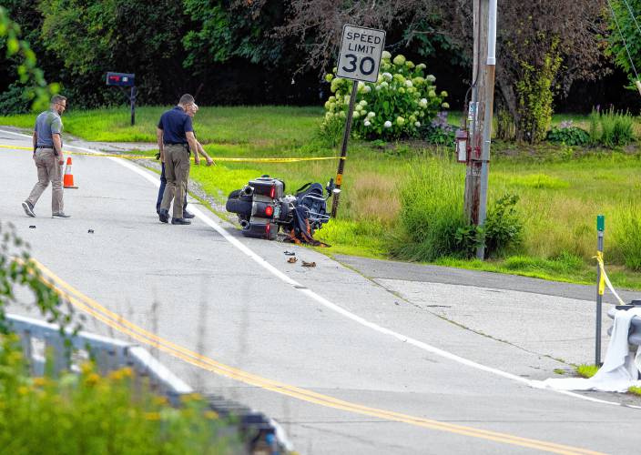 Concord police look over a motorcycle crash scene where the driver was killed on Washington Street in Penacook across from Fowler Street on Monday afternoon, July 15, 2024.