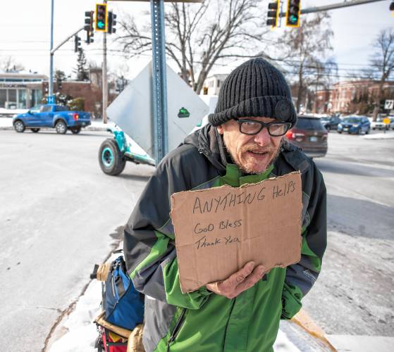 Raymond Blodgett asks for donations at the end of I-393 as it spills out into North Main Street in Concord on Tuesday, January 21, 2025. After hours in the cold, he had one donation of five dollars.