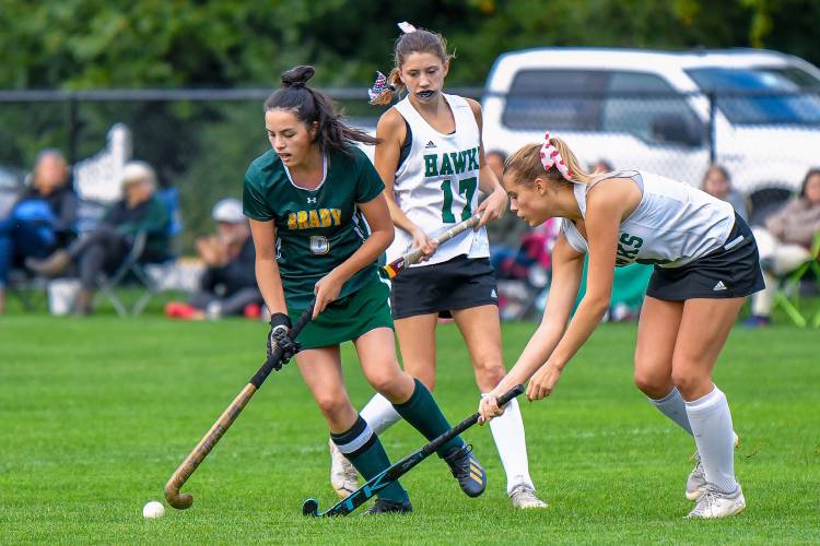 Bishop Brady’s Laura Yap (left) keeps the ball away from Hopkinton’s Autumn Meier (right) and Lauryn Vetter (17) during a game at Hopkinton Middle High School on Oct. 13. Bishop Brady won 6-0.  Yap was named the Division III Defensive Player of the Year.