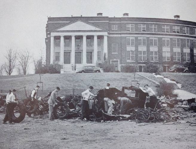 The war was being fought and many Concord service men and women were away. Here we see the students at Concord High School conducting a scrap metal drive in front of the school to do their part for the war effort.