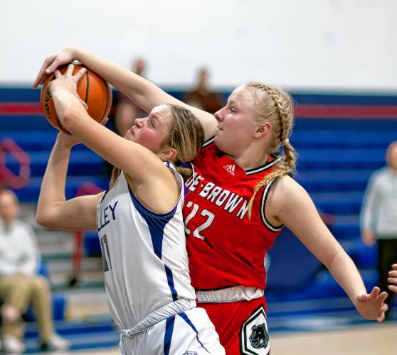 Coe-Brown center Kalina Kasprzak blocks a shot from Merrimack Valley forward Kayla Smith during a game in December.