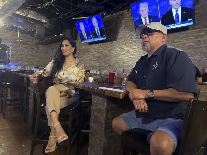 Marco Perez, 53, sits with Virginia López, 51, at a McAllen, Texas bar Thursday June 27, 2024. López is unsure which way she's voting. 