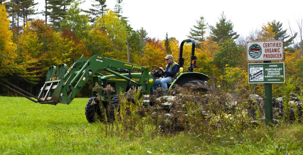 Dan Wolf of Newbury on his tractor in a field that he grows organic hay as well as organic eggs on 200 acres on Friday, October 15, 2021.