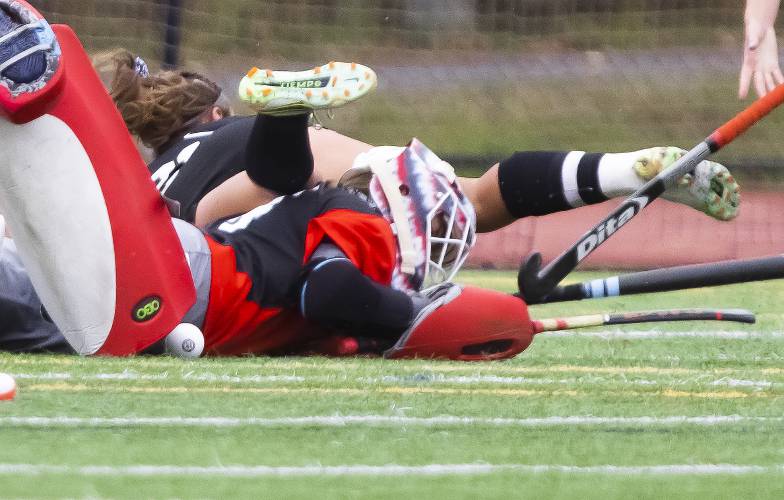 John Stark goalie Addyson Pelletier blocks a shot as a Kennett player falls over on to her during the second half at Bedford High School on Sunday, October 29, 2023. Pelletier shut out Eagles as Stark won, 1-0.