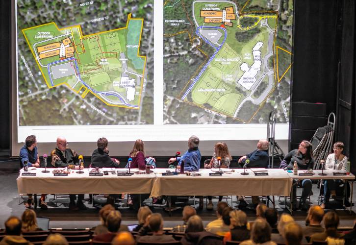 The Concord School Board looks up at the two site plans for the Rundlett Middle School at the opening of the meeting on Wednesday. The board voted to build the new school on the Broken Ground School site.