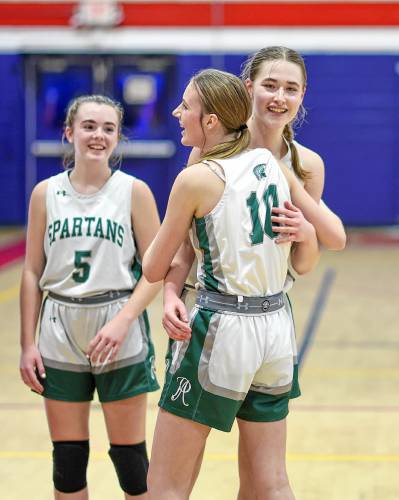 Left: Pembroke’s Annelise Dexter gets a hug from Kate Stephens (10) and Anne Phillips (5) after scoring her 1,000th career point in Friday’ girls’ third-place game.