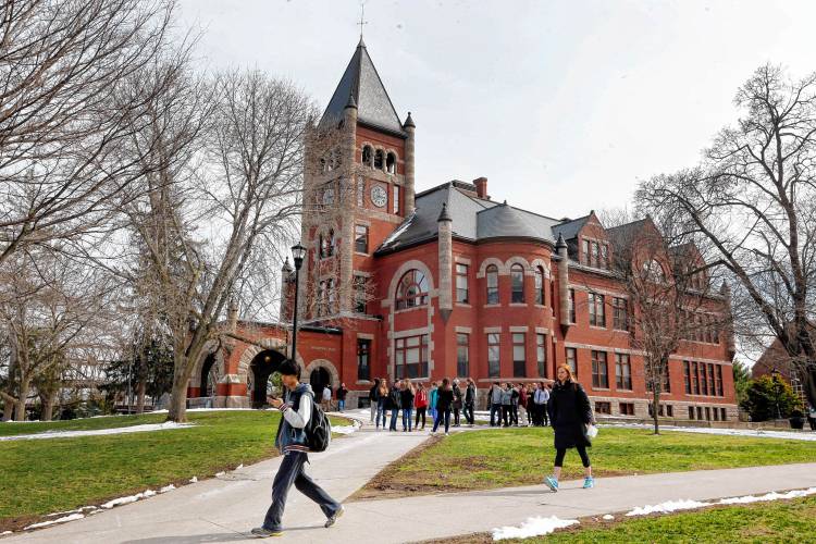 In this photo taken Wednesday, April 6, 2016 students walk past the historic Thompson Hall at the University of New Hampshire in Durham, N.H. In this photo taken Wednesday, April 6, 2016 students walk past the historic Thompson Hall at the University of New Hampshire in Durham, N.H.