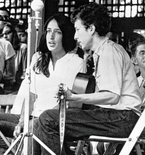 In this 1963 file photo, Joan Baez and Bob Dylan perform at the Newport Folk Festival in Newport, R.I. Two years later, on the night of July 25, 1965, Dylan strode onto a stage at the Newport Folk Festival, plugged in an electric guitar and gave the music world a shock. In this 1963 file photo, Joan Baez and Bob Dylan perform at the Newport Folk Festival in Newport, R.I. Two years later, on the night of July 25, 1965, Dylan strode onto a stage at the Newport Folk Festival, plugged in an electric guitar and gave the music world a shock.