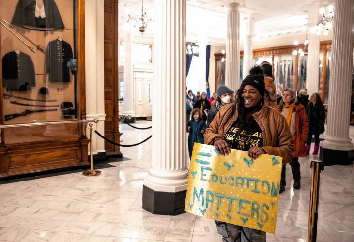 Sarah Georges of UNH Leadership Series leads the group of special education advocates marching around the State House after their rally at the State House on Tuesday, January 13, 2025.