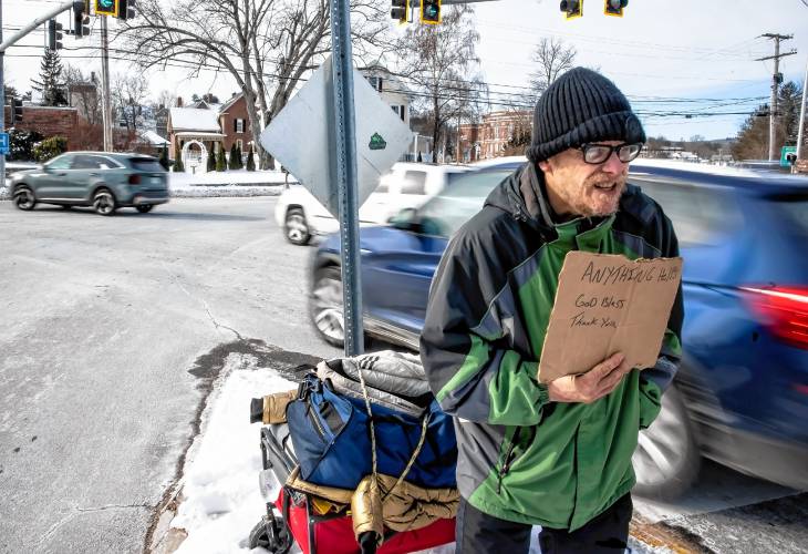 Raymond Blodgett asks for donations at the end of I-393 as it spills out into North Main Street in Concord on Tuesday. After hours in the cold, he had one donation of five dollars.