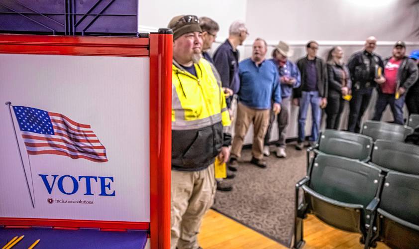 Alex Marrion of the Pembroke Department of Public Works gets ready to vote at Town Meeting on Saturday.