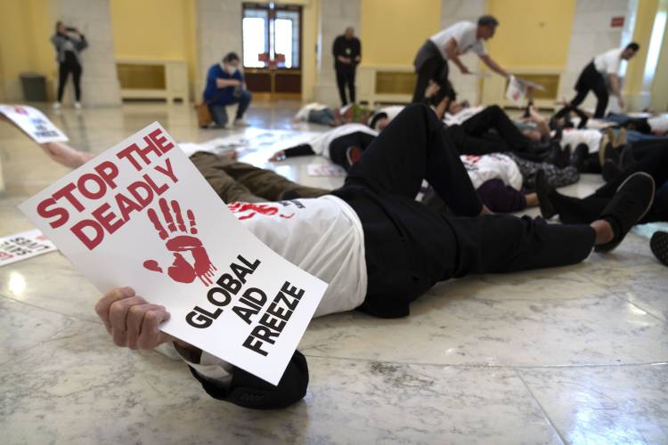Demonstrators protest against cuts to American foreign aid spending, including USAID and the PEPFAR program to combat HIV/AIDS, at the Cannon House Office Building on Capitol Hill, Wednesday, Feb. 26, 2025, in Washington. (AP Photo/Mark Schiefelbein) Demonstrators protest against cuts to American foreign aid spending, including USAID and the PEPFAR program to combat HIV/AIDS, at the Cannon House Office Building on Capitol Hill, Wednesday, Feb. 26, 2025, in Washington. (AP Photo/Mark Schiefelbein)