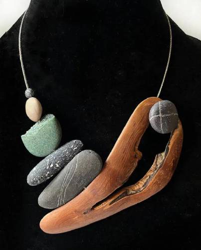 Two Villages Art Society's newest exhibit, “Whose Woods These Are, I Think I Know,” features the work of Kathleen Dustin, Dan Dustin, and Donna Zils Banfield. Pictured: a necklace of wood and stone, created by Kathleen Dustin