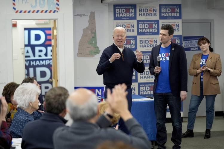 President Joe Biden, third from right, greets supporters during a visit to a campaign field office in Manchester, N.H., on Monday.