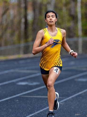 Bow’s Julia Hou leads the way during the girls’ 1,600-meter race in a track meet at Bow High School on Saturday. Hou won the 1,600, triple jump, pole vault and ran on the winning 4x400 relay to help lead the Falcons to a victory over Pembroke and Kingswood.