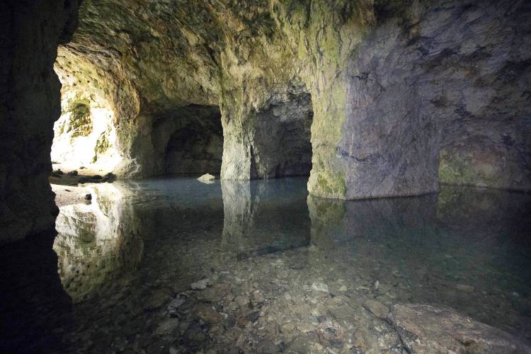 This June 7, 2016 file photo shows flooded caves at Ruggles Mine in Grafton, N.H. The former mica mine attracted tourists for decades before being closed and put on the market in 2016. It is now reopening.