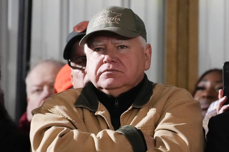 FILE - Minnesota Gov. Tim Walz listens as President Joe Biden speaks at Dutch Creek Farms in Northfield, Minn., Nov. 1, 2023. (AP Photo/Andrew Harnik, File)