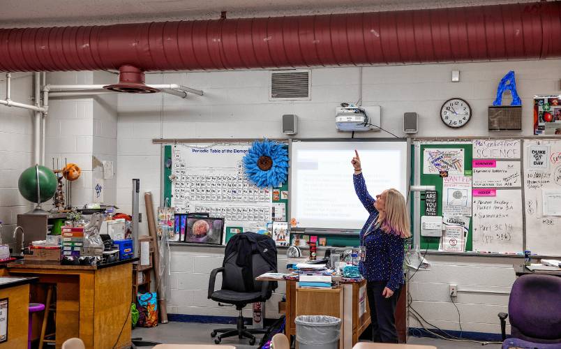 Rundlett science teacher Amy Schaeffner points to the water leak spot above her desk in her classroom on Monday, October 21, 2024. Schaeffner had to buy another trash basket to catch the water when it rains.