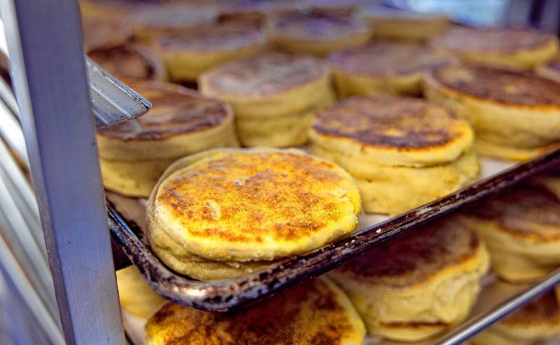 Homemade English muffins cool on a rack at the Table bakery.