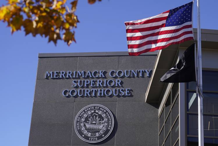 FILE - An American flag flies outside Merrimack County Superior Courthouse in Concord, N.H., Sunday, Oct. 11, 2020. FILE - An American flag flies outside Merrimack County Superior Courthouse in Concord, N.H., Sunday, Oct. 11, 2020.