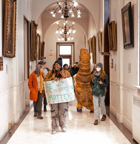 Sarah Georges of UNH Leadership Series leads the group of special education advocates marching around the State House after their rally at the State House on Tuesday.