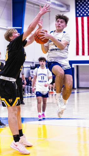 Concord Christian’s Luke Farland drives to the basket against Pittsburg-Canaan on Monday night. Farland scored a team-high 16 points, eight of them in the fourth quarter, to lead the Kingsmen to a 68-57 victory over the Yellow Jackets in the Division IV boys’ basketball preliminary round. Concord Christian’s Luke Farland drives to the basket against Pittsburg-Canaan on Monday night. Farland scored a team-high 16 points, eight of them in the fourth quarter, to lead the Kingsmen to a 68-57 victory over the Yellow Jackets in the Division IV boys’ basketball preliminary round.