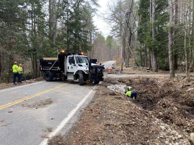 Concord General Services crew works on a culvert underneath Elm Street in Penacook that was overrun by water after a beaver dam collapsed on Dagody Hill on Tuesday, April 15, 2025.