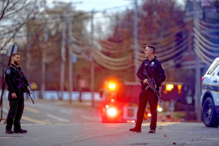 Police officers stand on Clinton Street after a shooting at the New Hampshire Hospital on Friday afternoon, November 17, 2023.