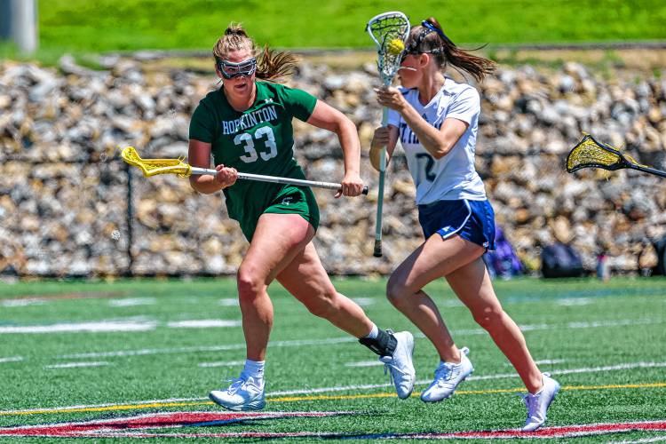 Hopkinton junior Sydney Westover (33) tries to slow down Charlotte De Tolla during the Hawks' D-III semifinal loss to St. Thomas on Saturday, June 1, 2024.
