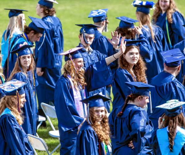 Members of the 2024 Merrimack Valley graduating class look out and wave at their friends and family during the commencement ceremony on Saturday morning, June 8, 2024.